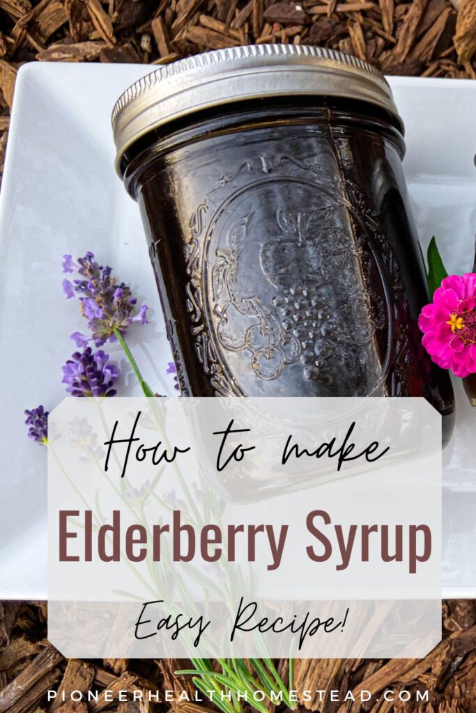 elderberry syrup on white dish with lavender flowers and zinnias