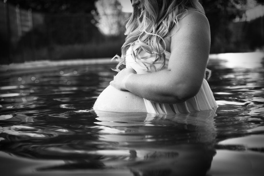 pregnant woman in pool black and white