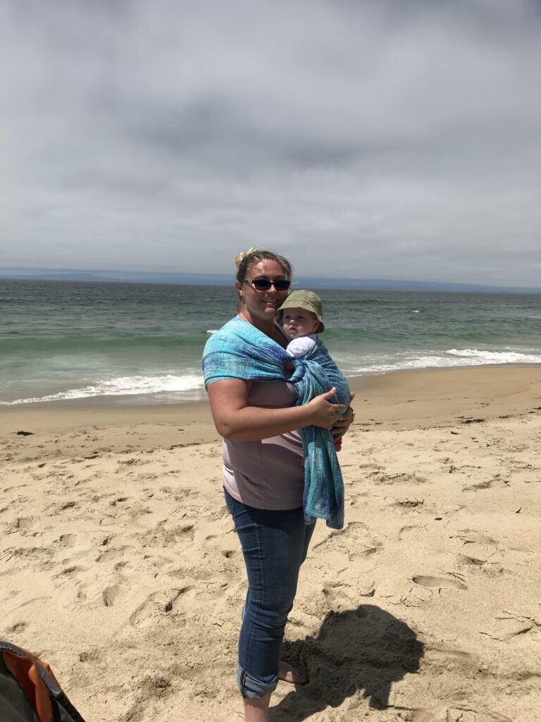mom and infant at beach using a ring sling