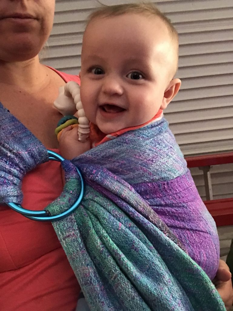 baby in a handwoven ring sling