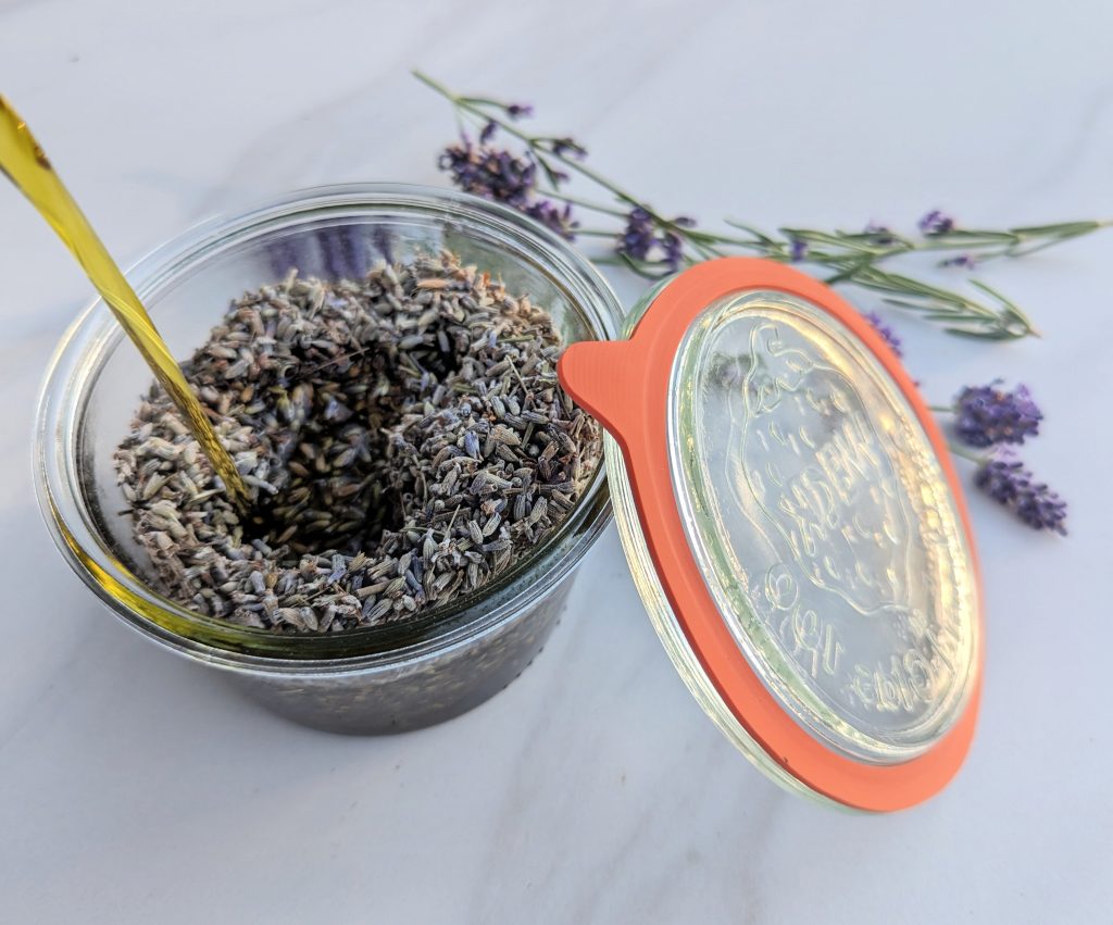 dried lavender flower in oil in a glass jar