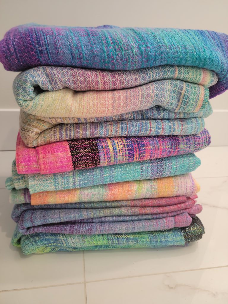 stack of handwoven baby wraps