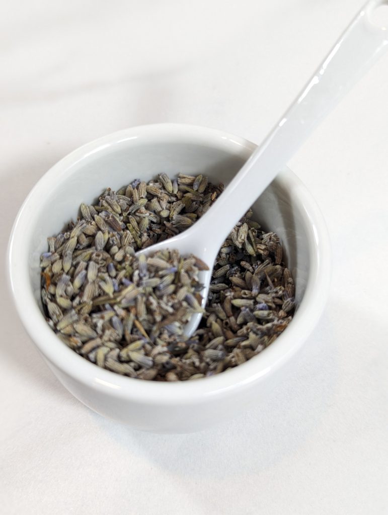 lavender herb in white cup with spoon