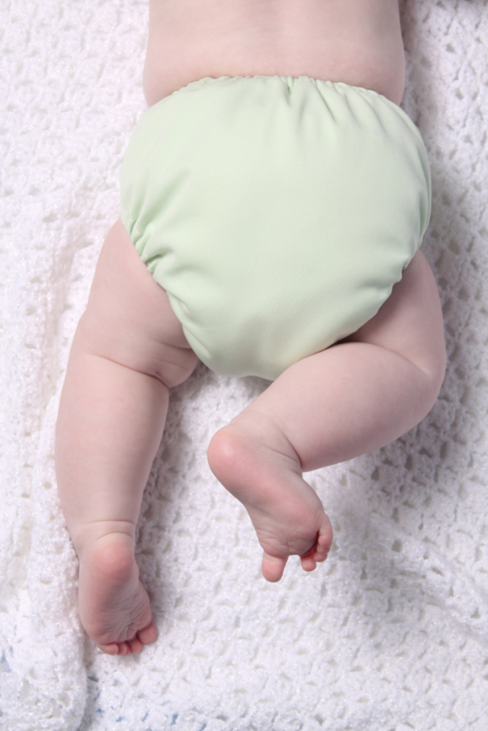 baby in light green cloth diaper