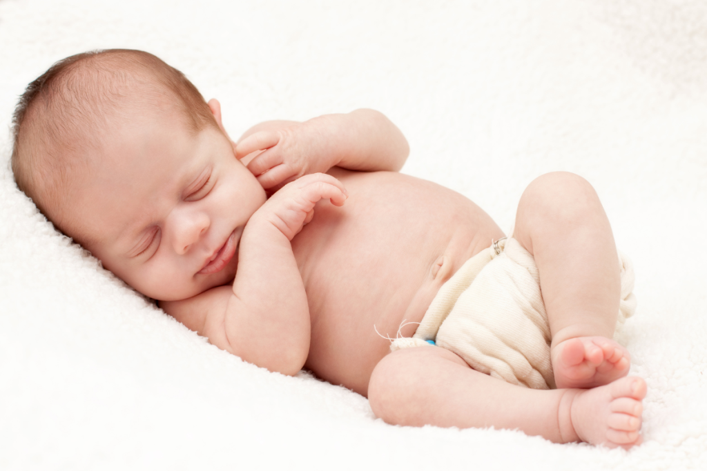 newborn baby in a prefold cloth diaper