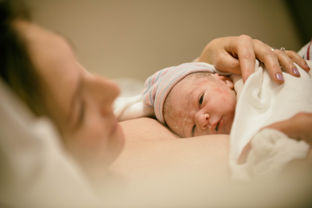 newborn baby on top of mom postpartum type of childbirth