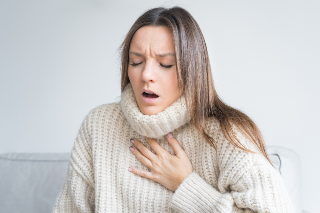 woman hard of breathing in sweater pic