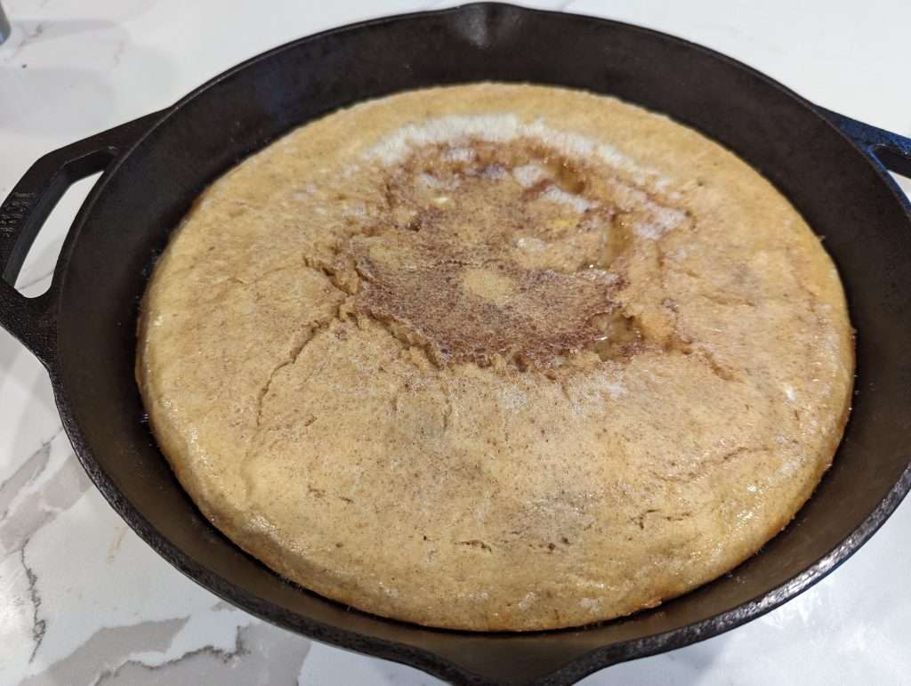sourdough dutch baby pancake in a cast iron skillet