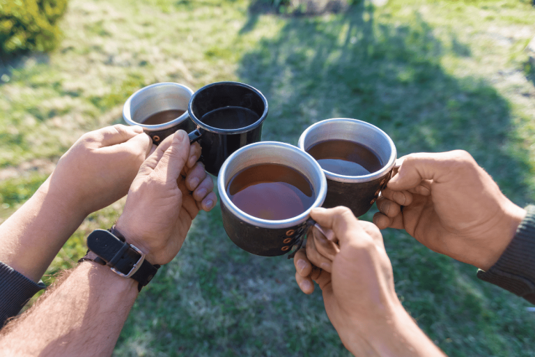 herbal tea for Men with tea in their mugs hands