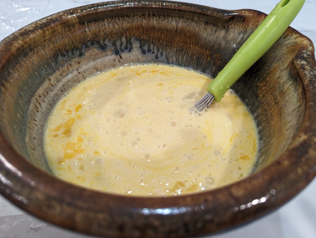 mixture of sourdough discard dutch baby pancake in ceramic bowl