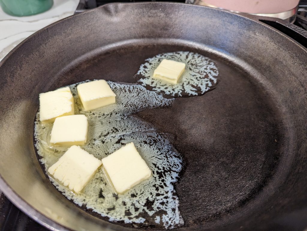 melting butter in cast iron skillet on gas stove