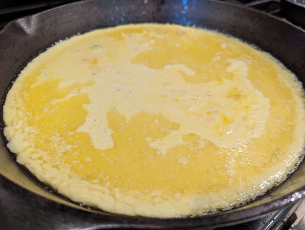 sourdough discard dutch baby pancake batter in cast iron skillet