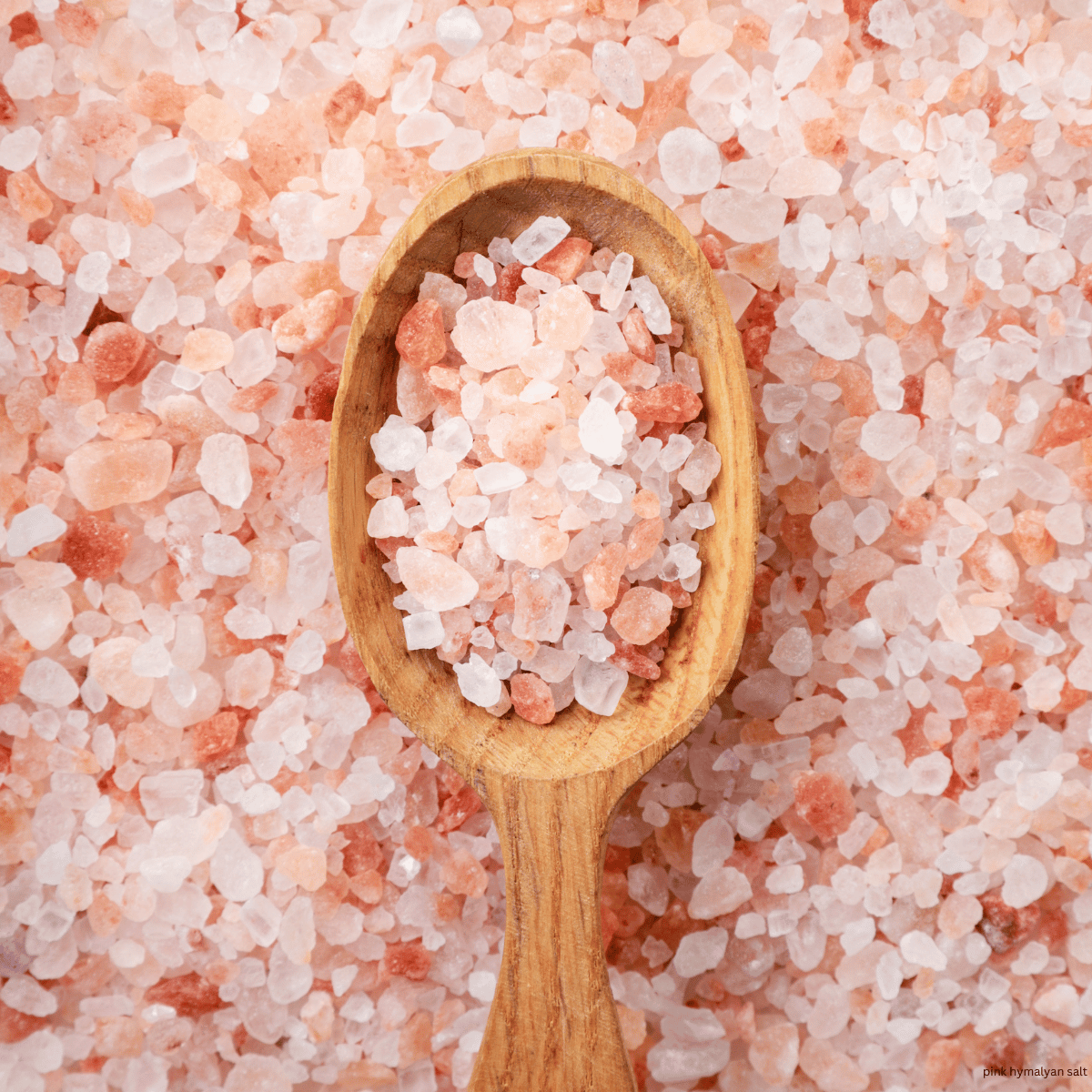 pink himalyan salt in wood spoon