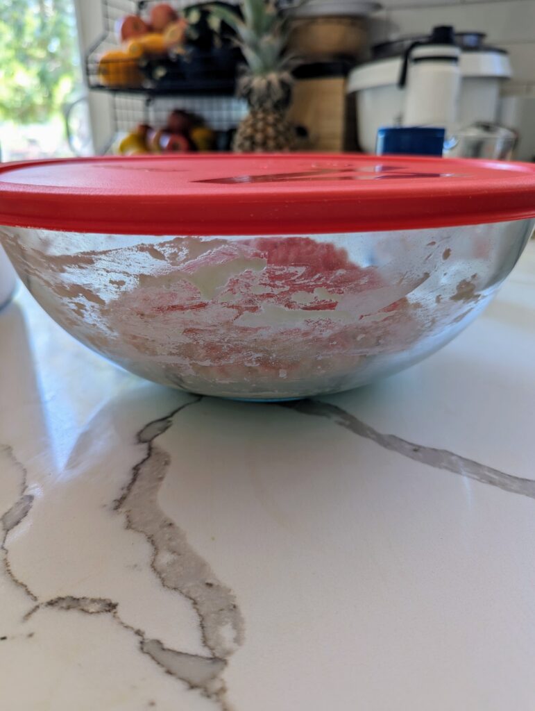 sourdough focaccia garden bread dough covered in glass bowl