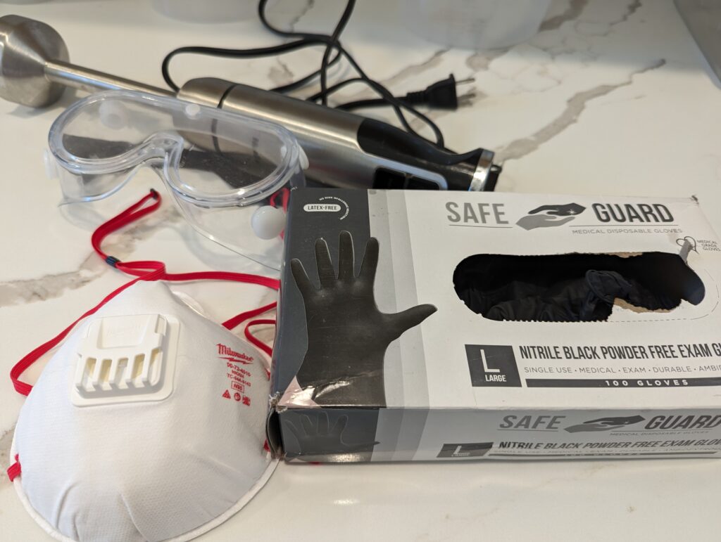 Safety items goggles, face mask, gloves and an immersion blender