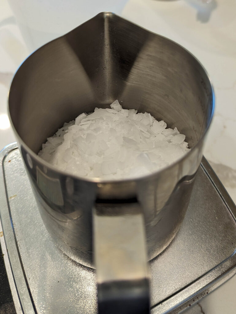 lye flakes in stainless steel container