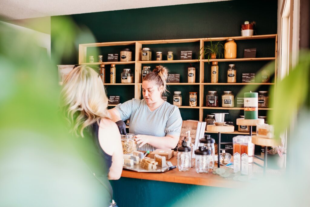 Serra Blaine at Vine and Branch shop measuring herbs