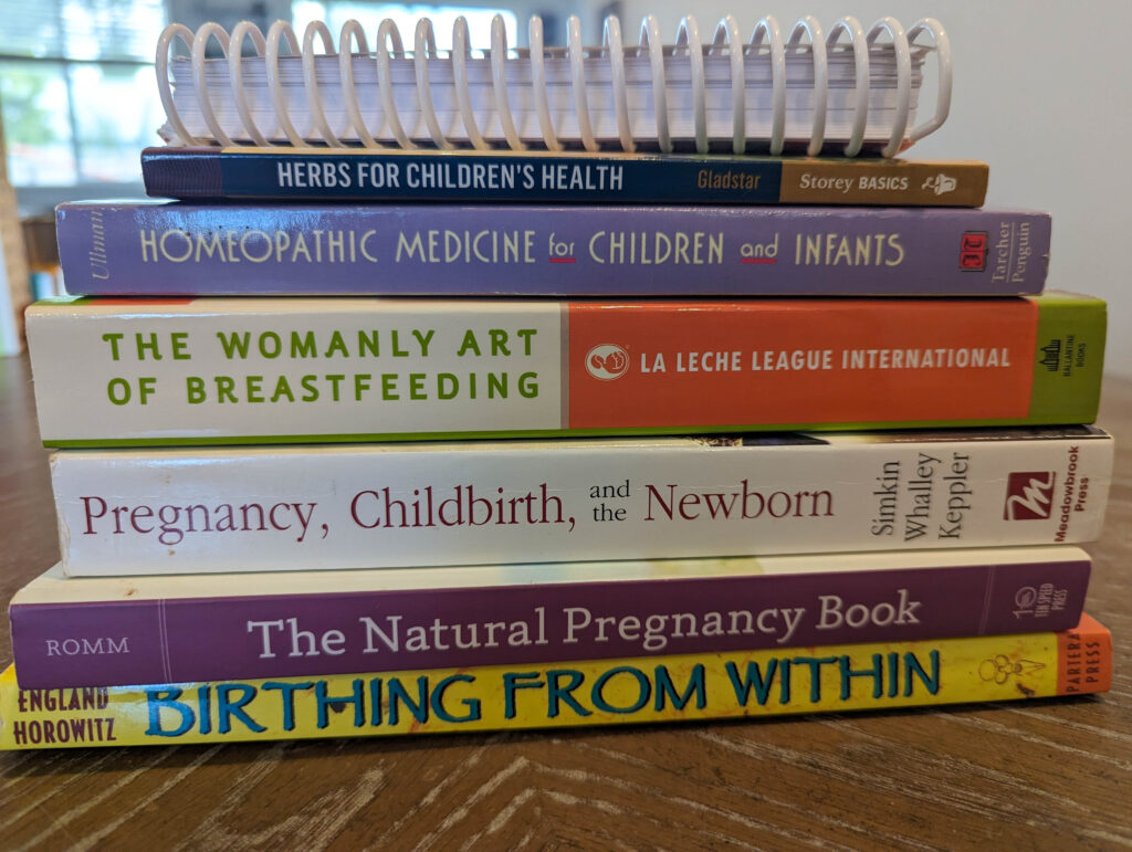 stack of pregnancy books on aa wood table