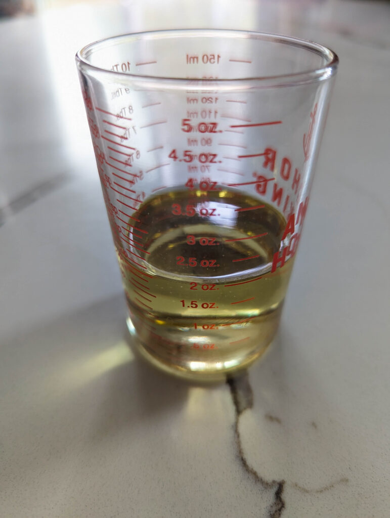 avocado oil in glass measuring cup