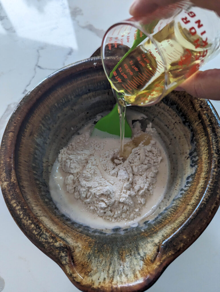 pouring avocado oil into ceramic bowl