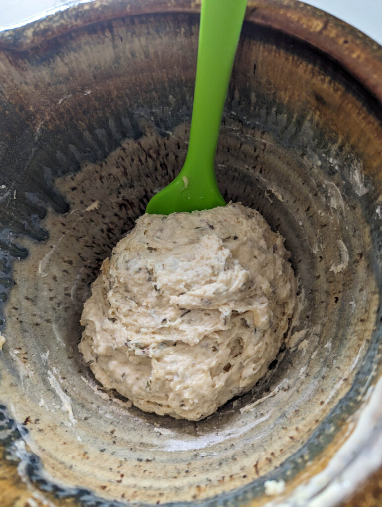 sourdough herb cracker dough mixed in ceramic bowl