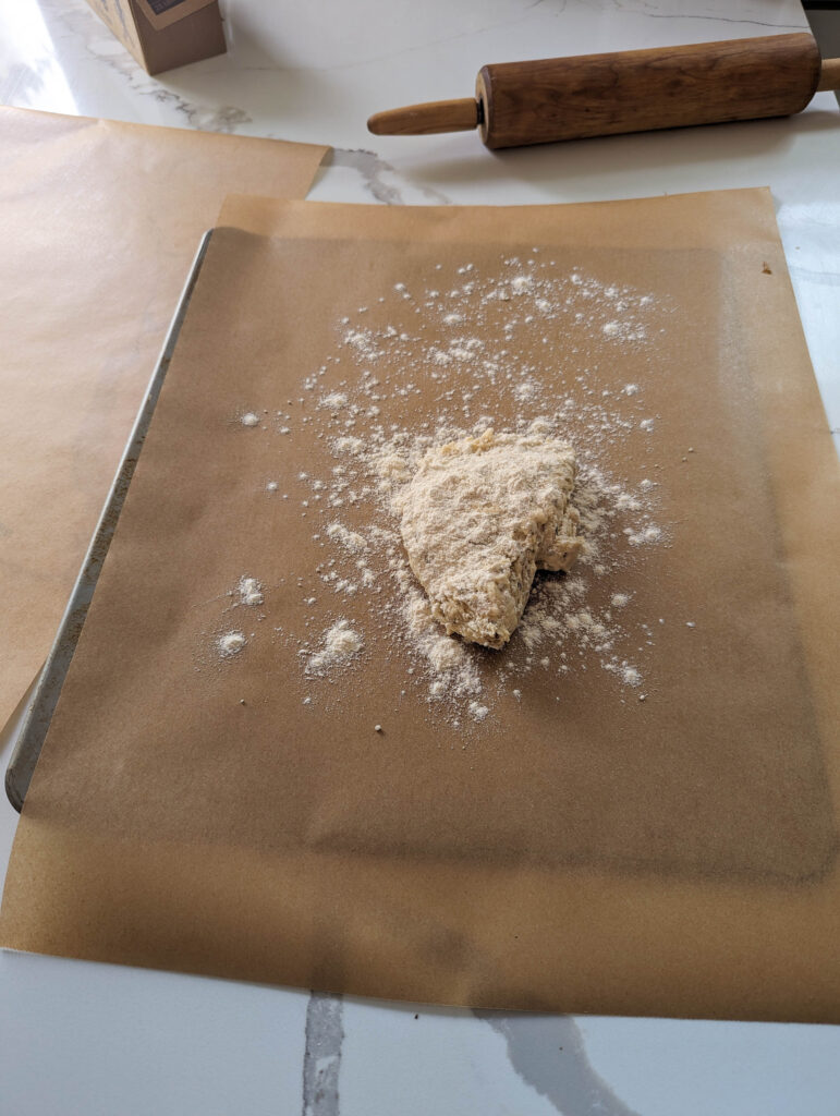 sourdough herb cracker dough on parchment paper