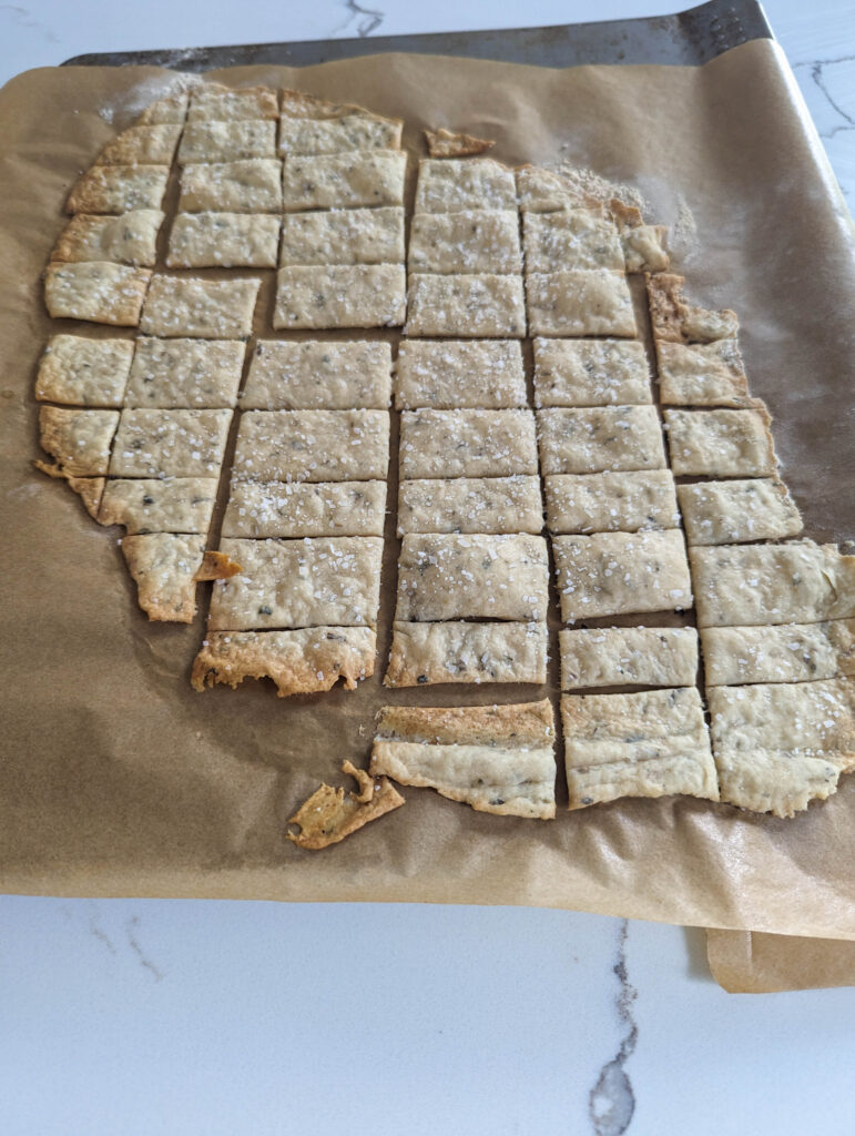 bakes sourdough herb crackers on parchment paper