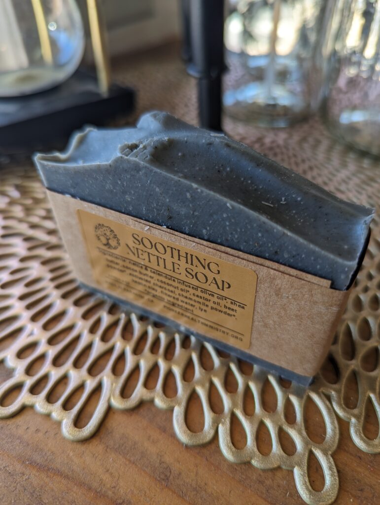 soothing nettle herbal soap on gold and wood