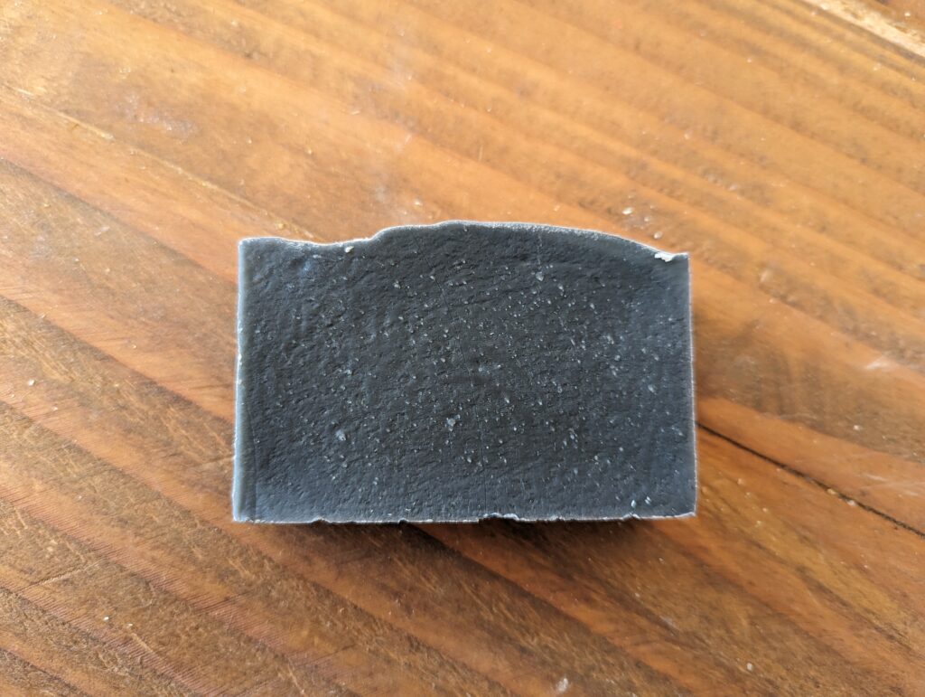 charcoal soothing nettle soap on wood counter