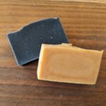 handmade herbal soaps on top of wood counter