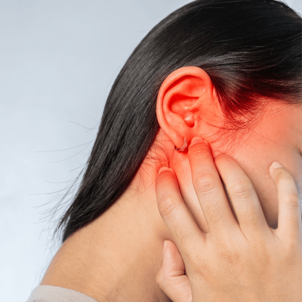 woman with ear infection, red ear and earing