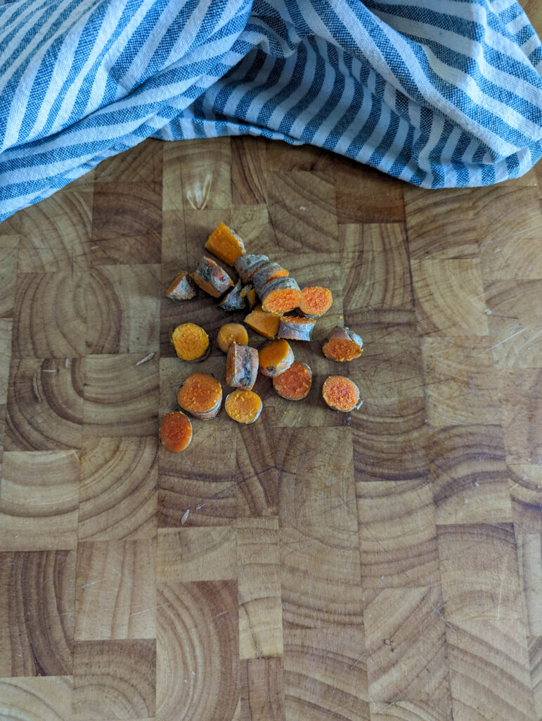 chopped turmeric root on wood cutting board