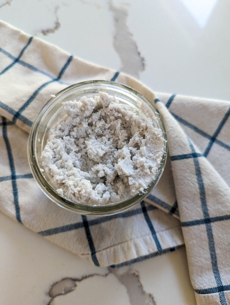 homemade toothpaste in mason jar on top of towel