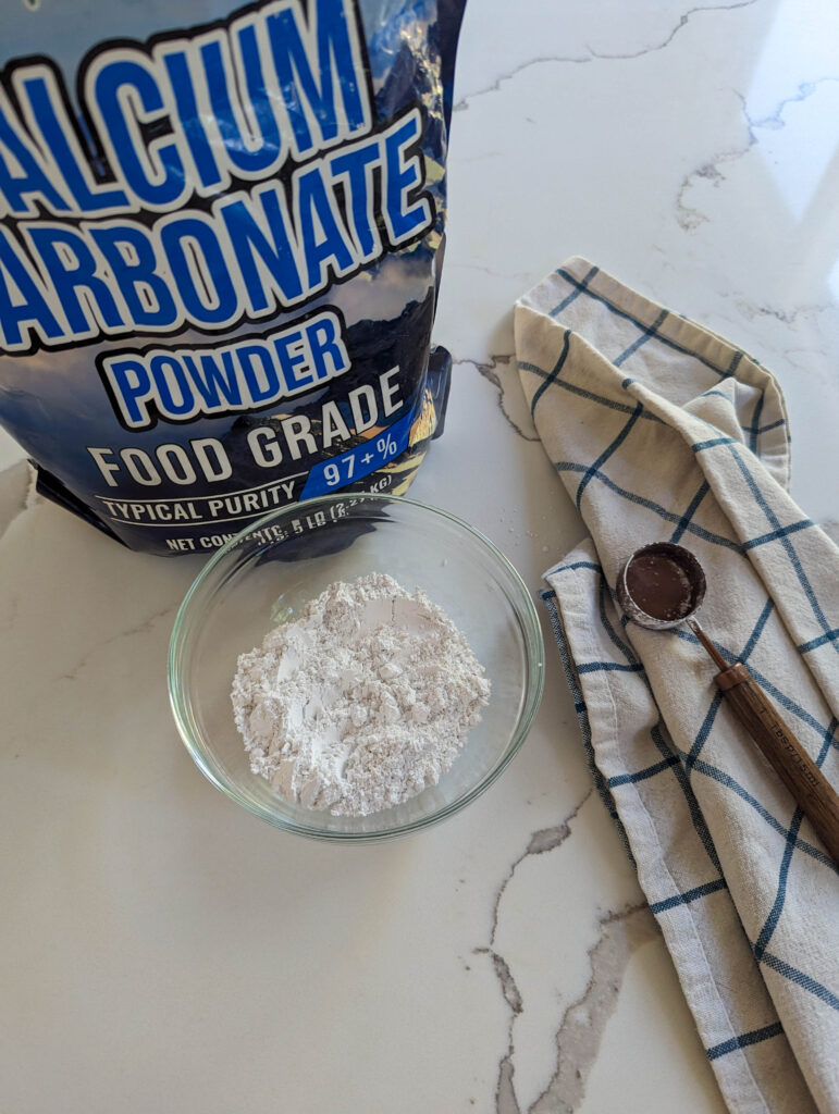 calcium carbnoate in a bag and bowl on white counter top