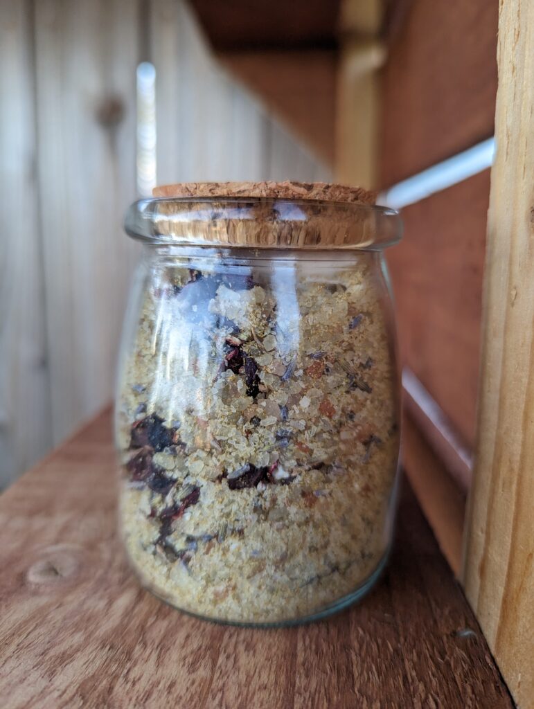 bath salts in glas jar with cork lid on wood farm stand