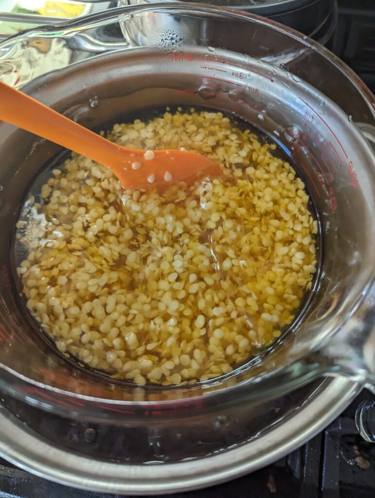 Melting beeswax in double boiler with silicone spatula