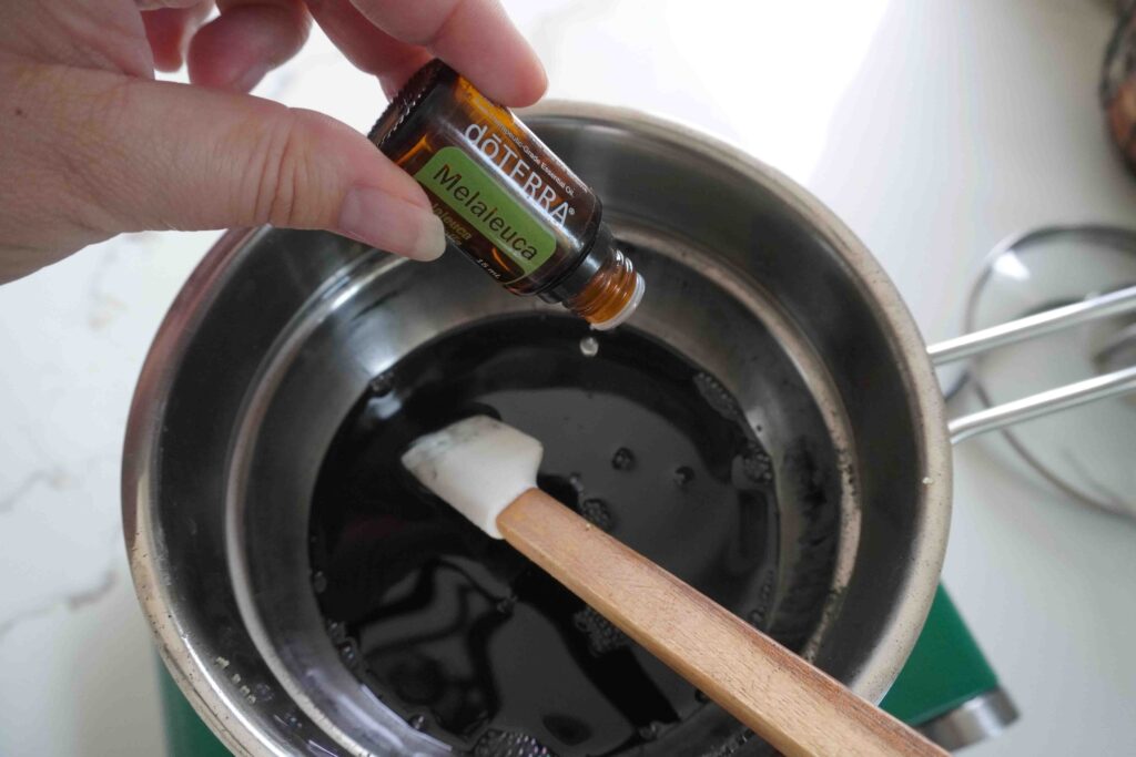 Drawing salve tea tree essential oil into double boiler