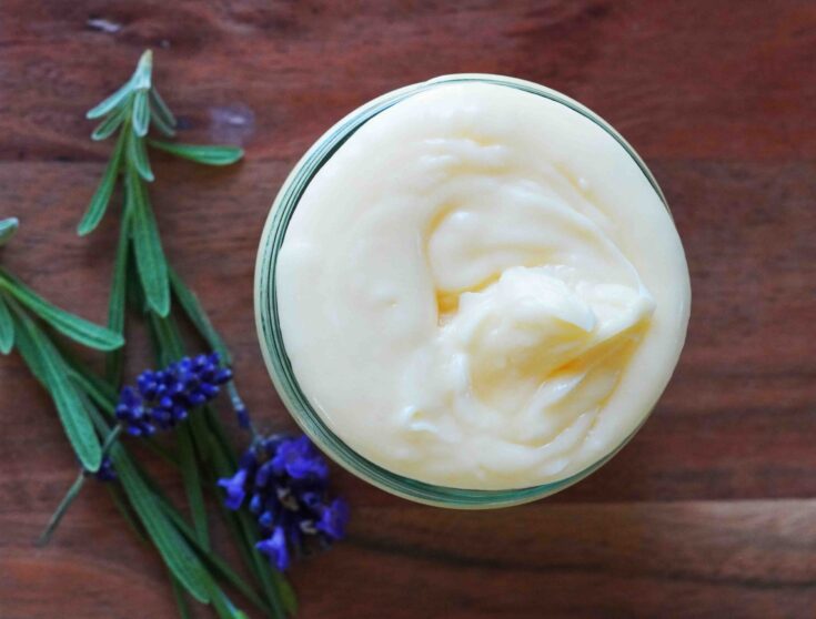 Magnesium lotion with Lavender flowers on wood cutting board