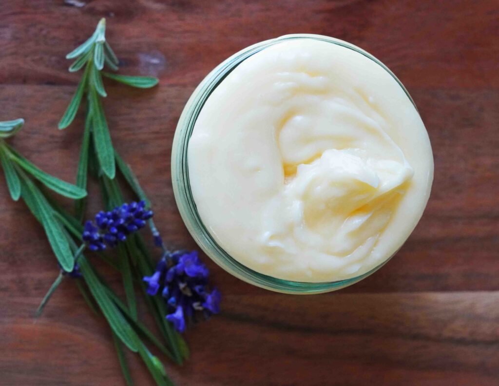 magnesium lotion with lavender flowers on wood