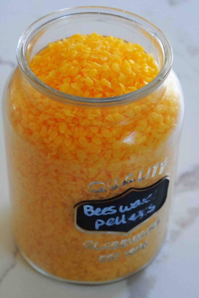 beeswax pellets in glass jar