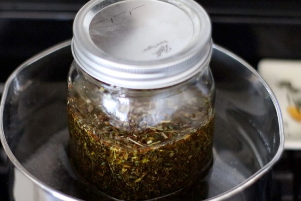 herbal burn salve oil in double boiler