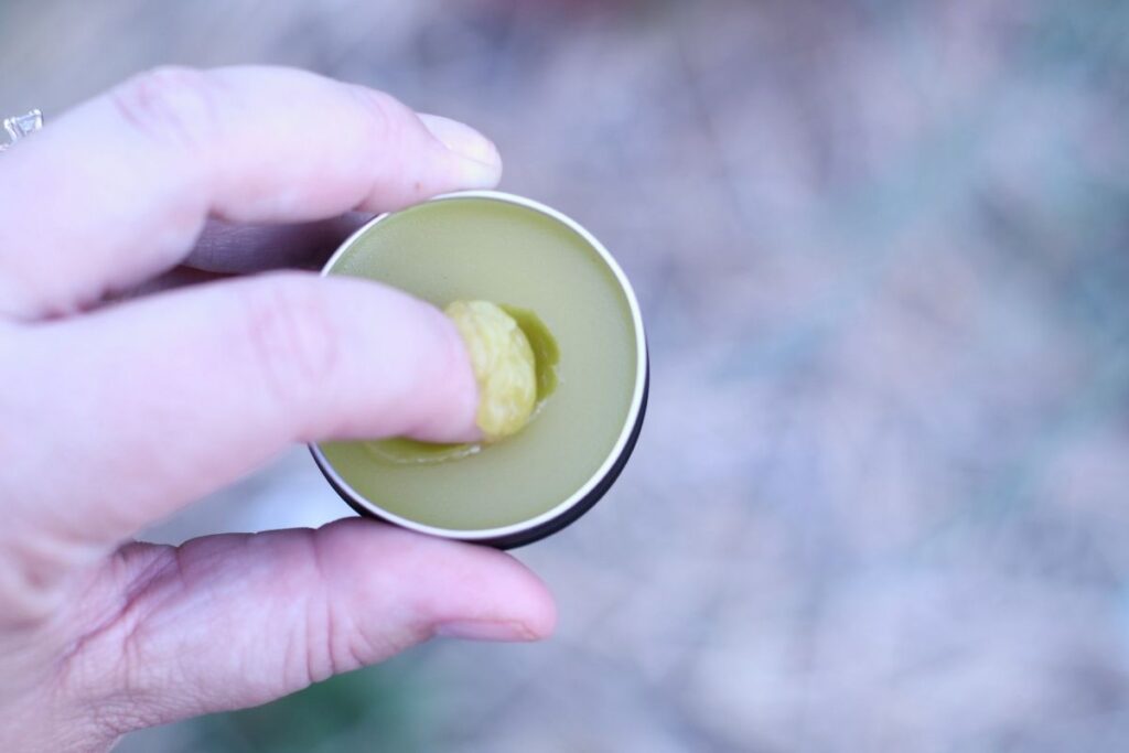 lemon balm salve with finger in it