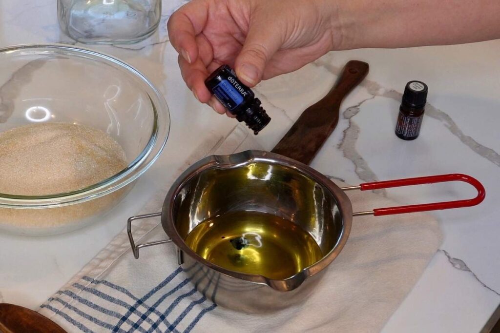adding blue tansy essential oil into melted oil