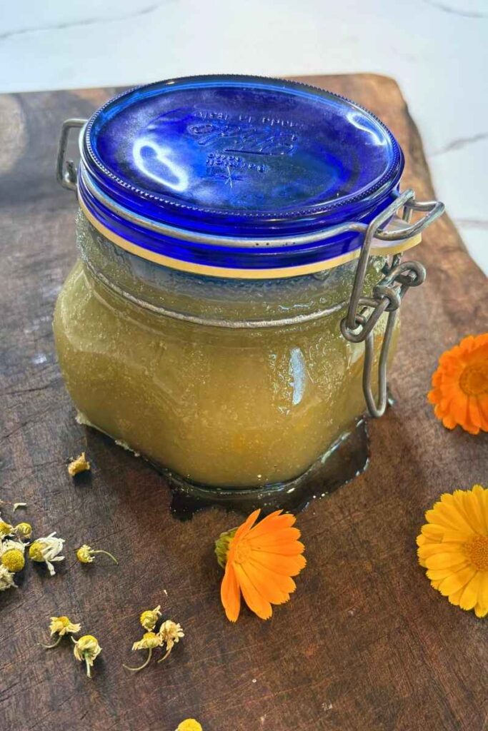 jared calendula & chamomile sugar scrub on wooden cutting board